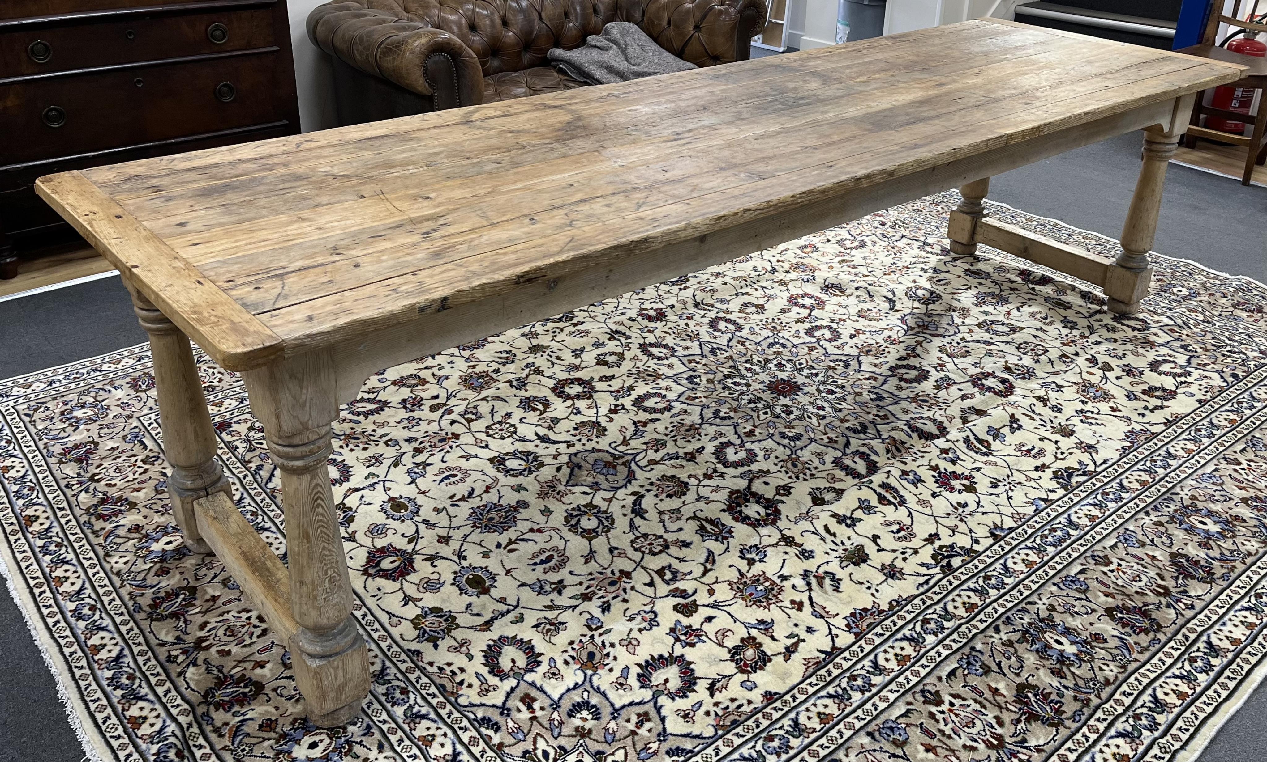 An 18th century style rectangular pine refectory dining table, width 283cm, depth 88cm, height 76cm. Condition - fair